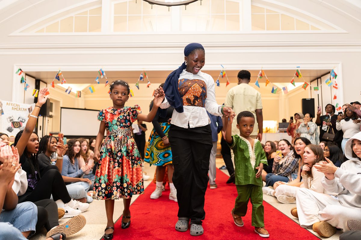 Students cheering on participants at the Cultural Outburst fashion show.