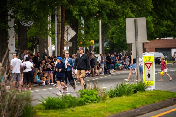 Windsor community members line the street just off campus awaiting the parade