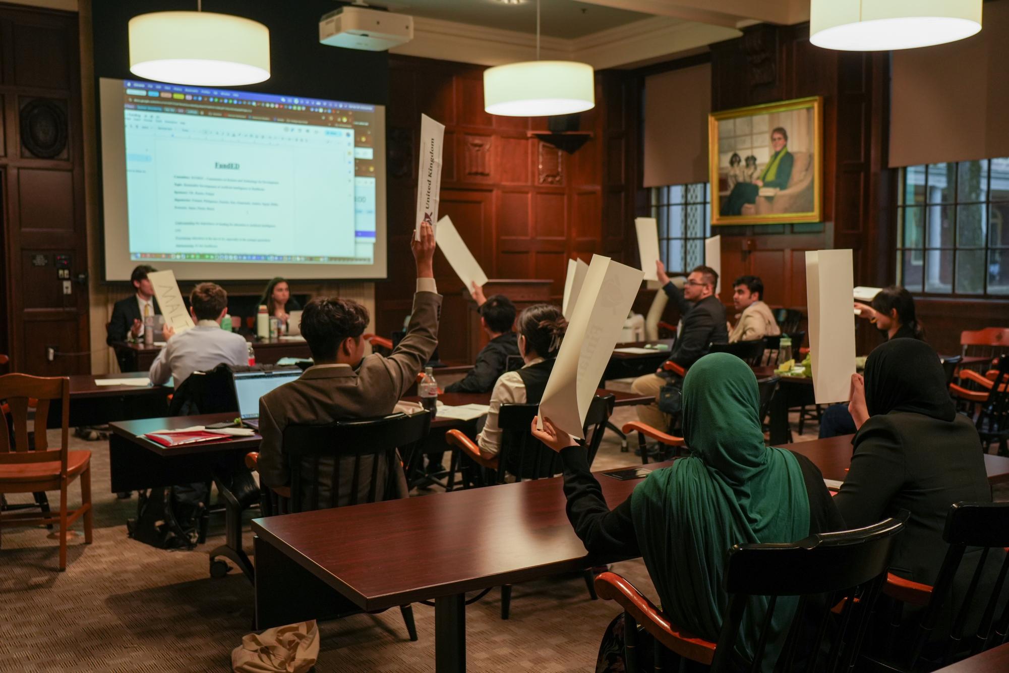 A LooMUN committee on the use of AI in healthcare in action in Founders Lounge.